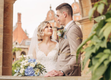A couple on their wedding day inside a stone pagoda in the grounds of a hotel