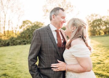 Bride and groom looking at each other in the glow of sunset