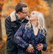 A couple embracing on a sunny autumnal day outdoors