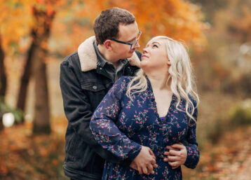 A couple embracing on a sunny autumnal day outdoors