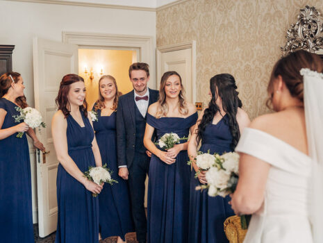 Bridesmaids seeing the bride ready in her dress for the first time