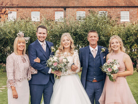 A wedding group photo of the bride, groom and bride's family